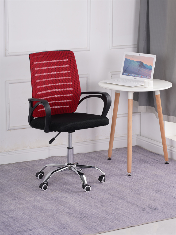 Red mesh ergonomic office chair with black padded seat, chrome swivel base, and curved armrests.