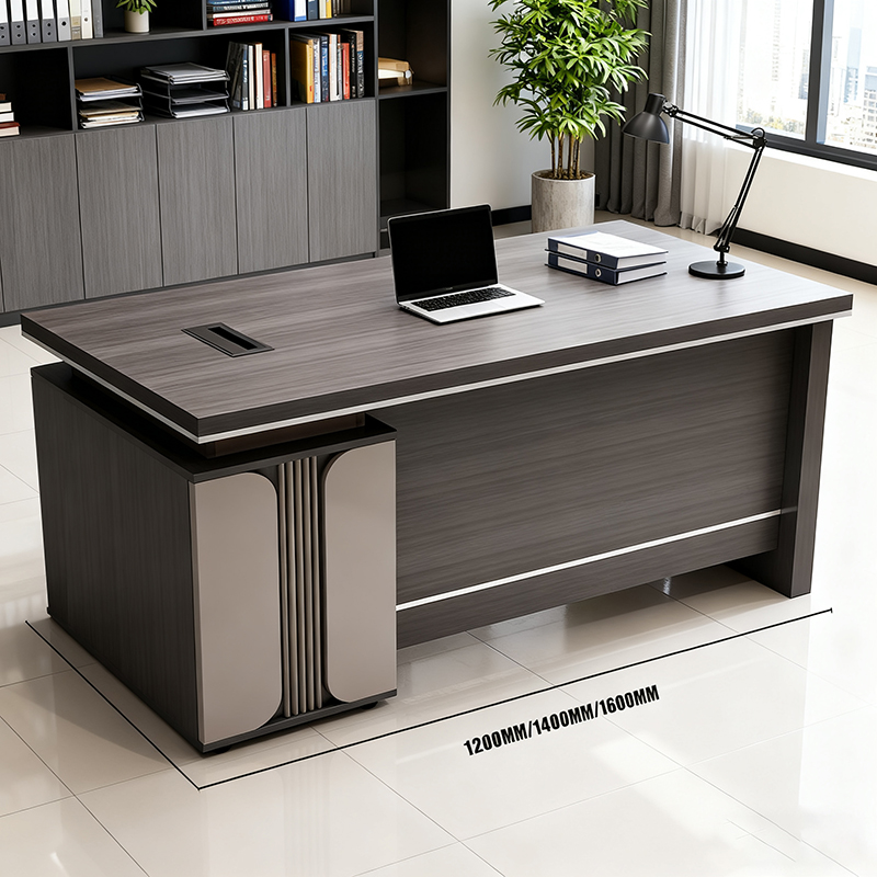 A compact wooden executive desk in a reddish-brown finish with carved front panels.