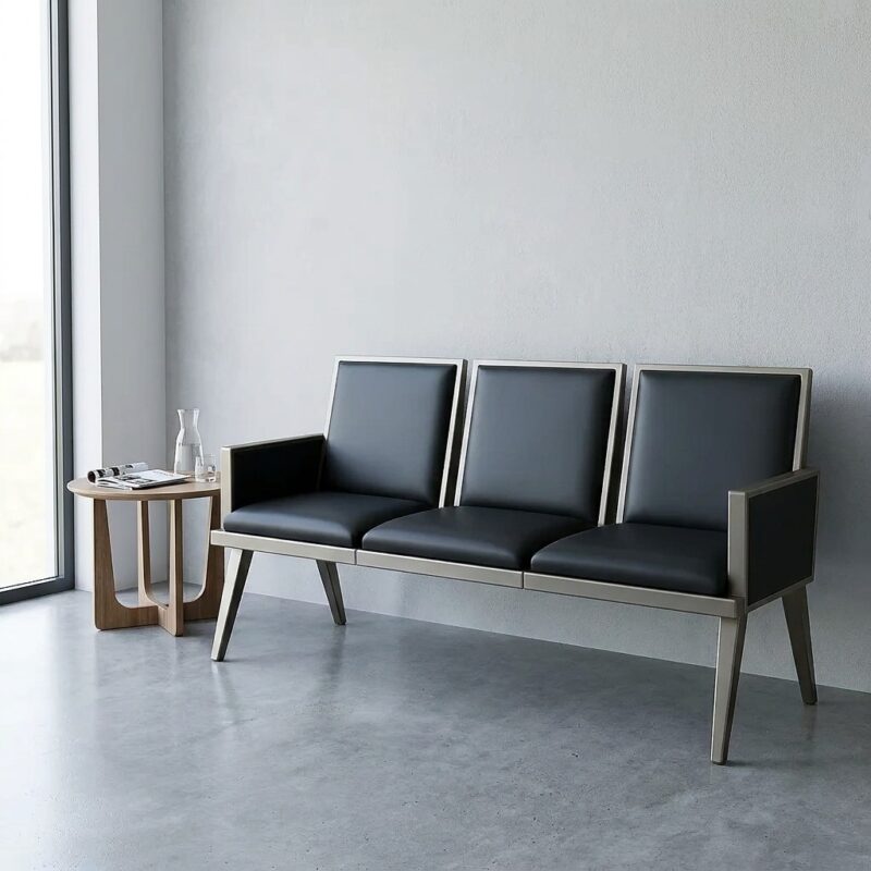 Modern 3-seater reception bench with black leather padded seats and a sturdy silver metal frame, designed for professional waiting rooms and office lobbies.