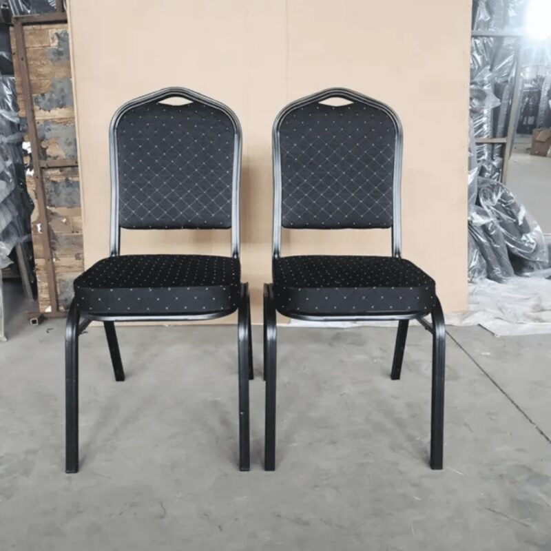 Black stackable banquet chairs featuring an arched crown-back backrest with diamond-patterned tufted upholstery, a thick padded seat cushion, a built-in top carrying handle, and a durable black metal frame.
