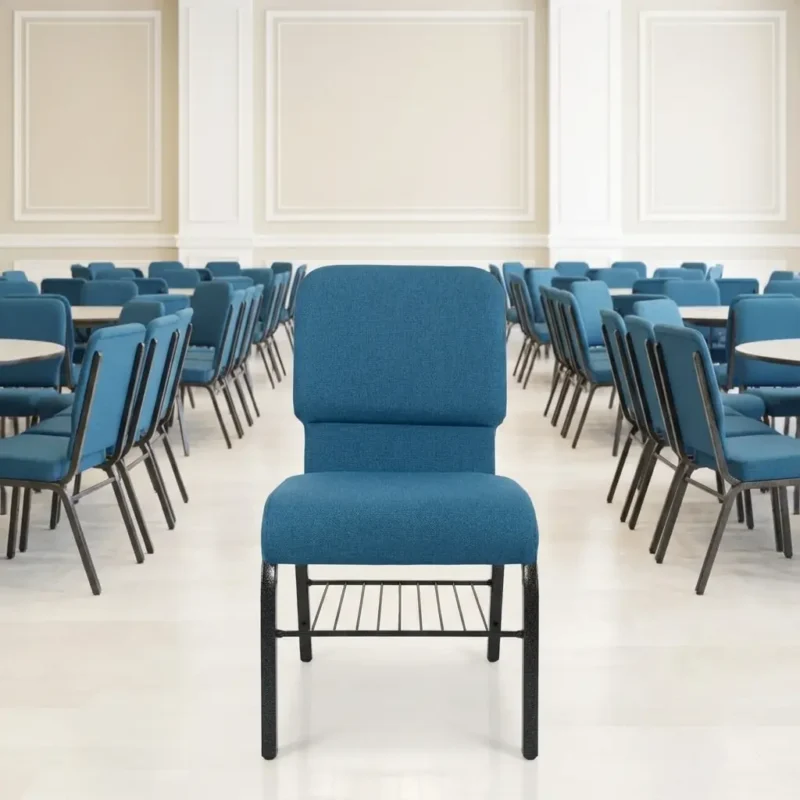 Teal blue upholstered auditorium chair featuring a cushioned high backrest, thick padded seat, built-in metal wire book rack under the seat, and a durable hammer-tone steel frame.