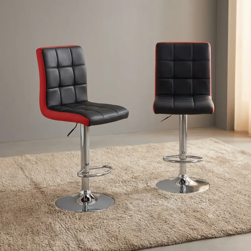 Modern adjustable swivel barstool in black and red faux leather with a tufted square-patterned seat, gas lift pedestal, chrome footrest, and round base at a kitchen counter.