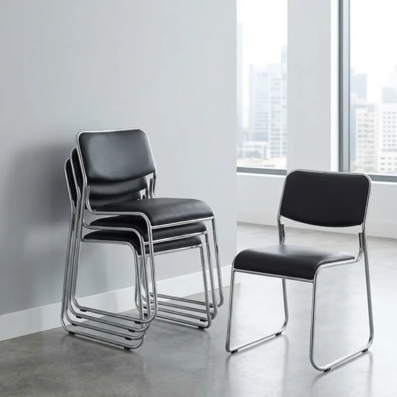 Stackable office waiting chairs featuring padded black leather seats and backrests, sleek chrome metal legs, and a space-saving nesting frame design shown both individual and stacked.