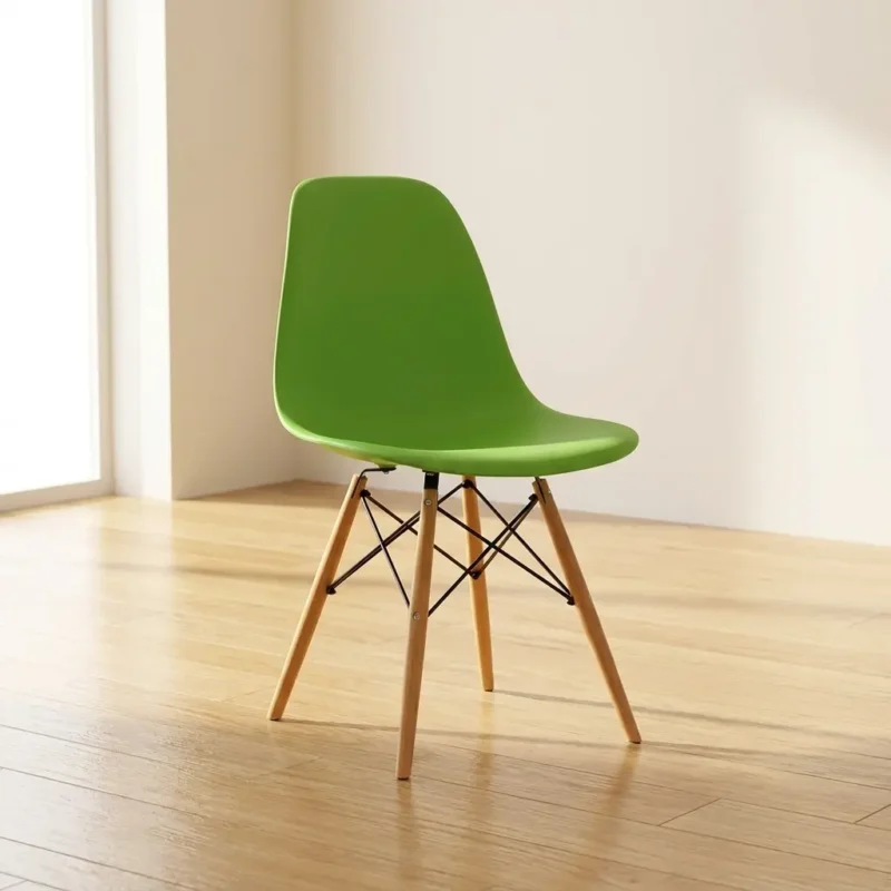 Green eames chair featuring a vibrant lime green molded plastic shell seat, supported by a classic Eiffel tower wooden base with splayed light timber legs and black metal wire cross-bracing.