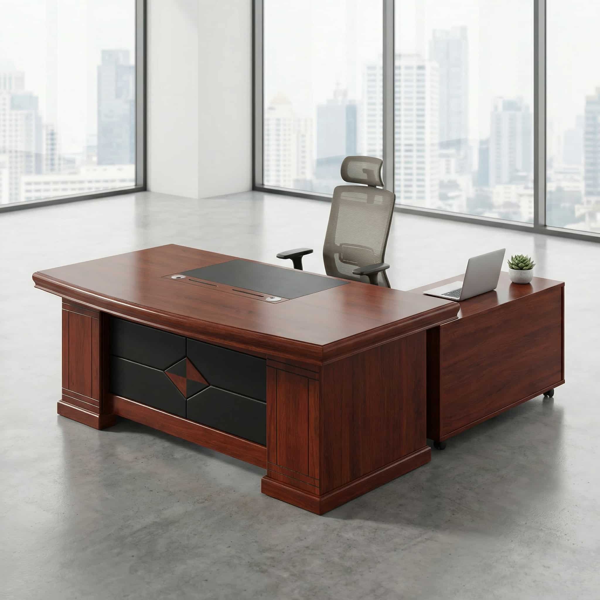 1600mm executive office table in a warm cherry wood finish, featuring an integrated black leather writing pad inlay, a matching L-shaped side return extension desk, and a black front modesty panel accented with a geometric diamond wood pattern.