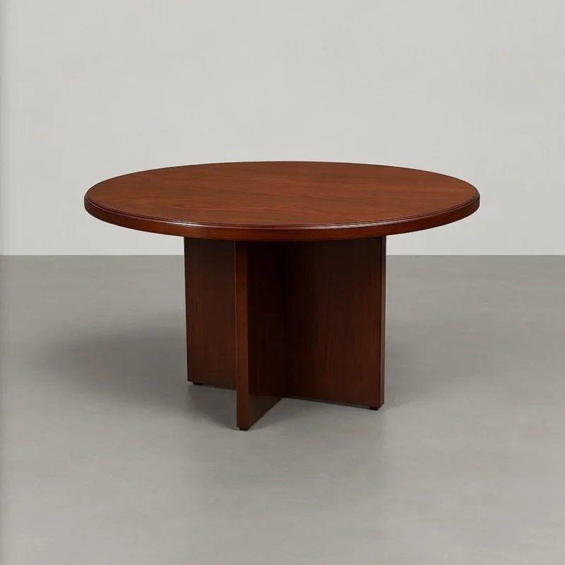 Round conference table in a rich cherry wood veneer finish, featuring a thick, circular tabletop with a classic bevelled edge detail, supported by a central, intersecting X-shaped wooden pedestal base.