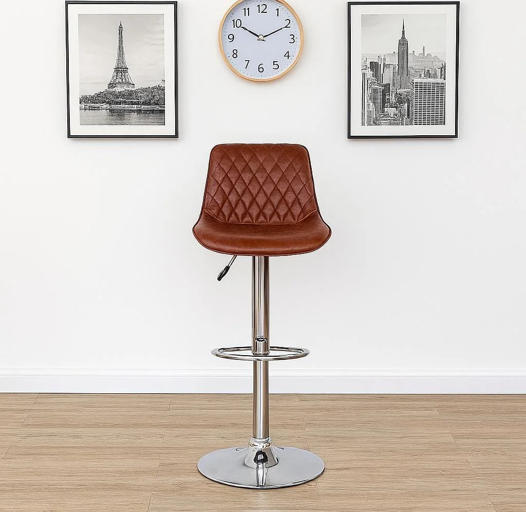Vintage-style brown leather adjustable barstool featuring a diamond-quilted upholstered bucket seat, a pneumatic gas lift adjustment lever, and a polished chrome pedestal base with an integrated circular footrest.