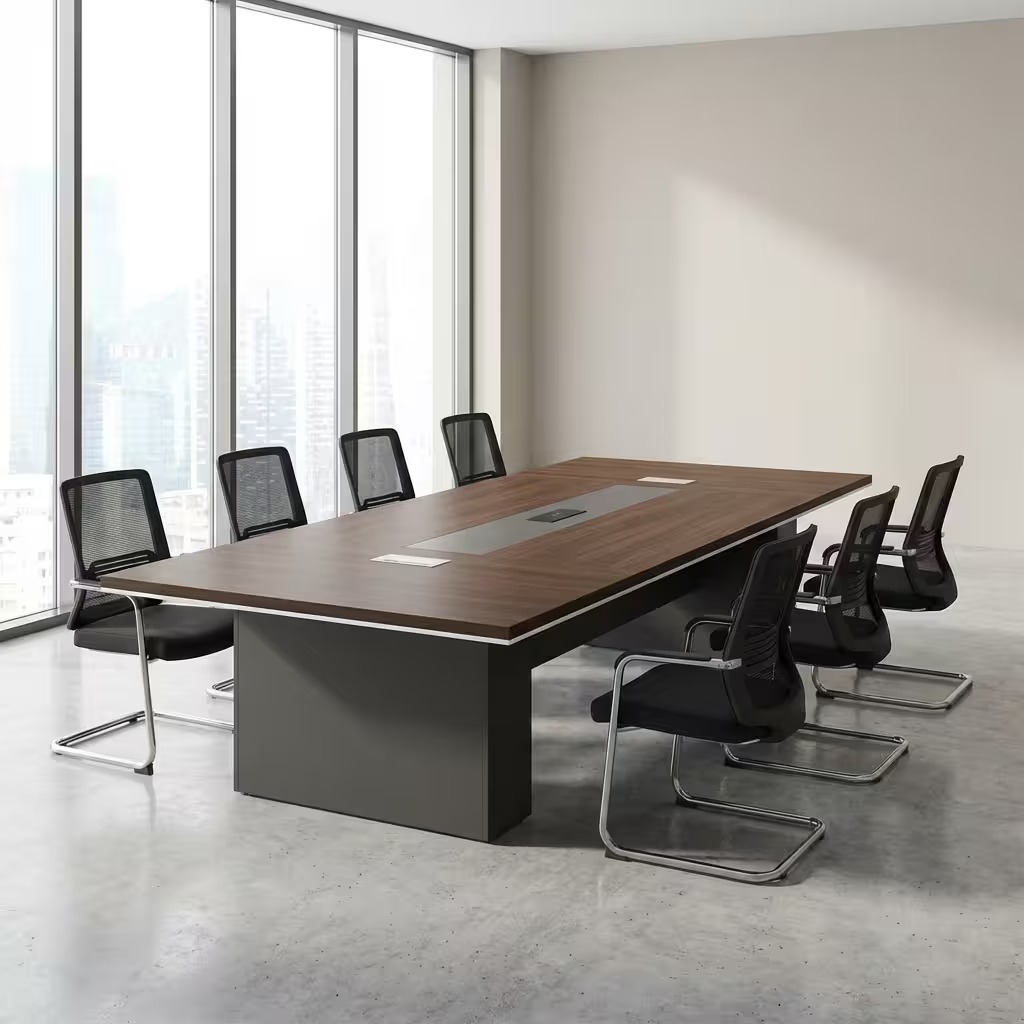 2.4m boardroom table featuring a premium walnut wood veneer tabletop with a modern white-edge trim, a central integrated grey cable management track with three pop-up power and data modules, supported by two robust grey rectangular pedestal bases.