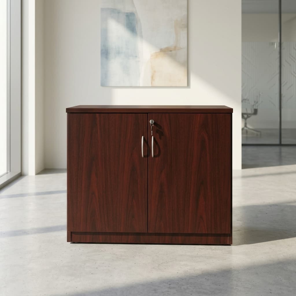 Wooden Executive office cupboard featuring a rich reddish-brown cherry wood grain veneer finish, a solid flat top surface, two swing cabinet doors with matching curved brushed silver handles, and a built-in top lock system with keys inserted.