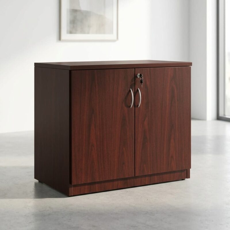 Wooden Executive office cupboard featuring a rich reddish-brown cherry wood grain veneer finish, a solid flat top surface, two swing cabinet doors with matching curved brushed silver handles, and a built-in top lock system with keys inserted.