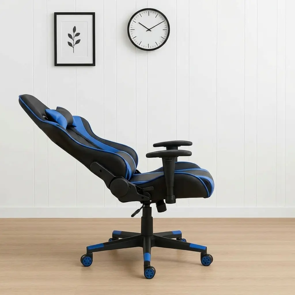 Ergonomic high-back gaming chair in black and blue leather, featuring matching adjustable lumbar support, a neck pillow, fixed T-shaped armrests, and a 5-star swivel star base with blue-trimmed caster wheels.
