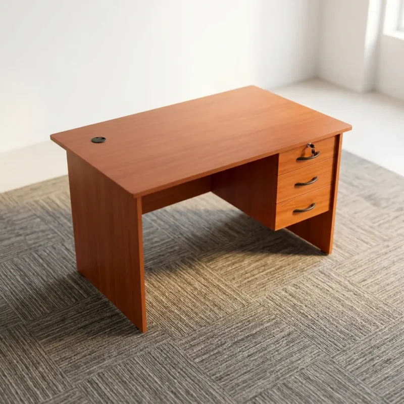 Compact 0.9m home office desk in a cherry wood grain finish, featuring a rectangular writing tabletop with a black cable grommet, a modesty panel, and an integrated right-hand three-drawer pedestal with black curved handles and a key-lock.