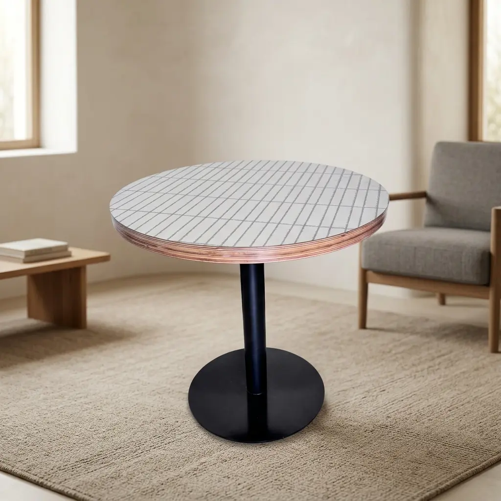 White circular dining table featuring a tabletop with a subtle linear grid pattern and exposed layered plywood edge detail, supported by a central black metal pedestal column and a heavy-duty flat circular base.