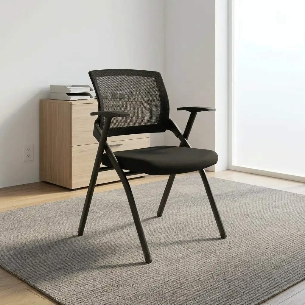 Black foldable office chair featuring a breathable black mesh backrest, contoured high-density foam seat upholstered in black fabric, integrated T-style armrests, and a collapsible matte black powder-coated metal frame.
