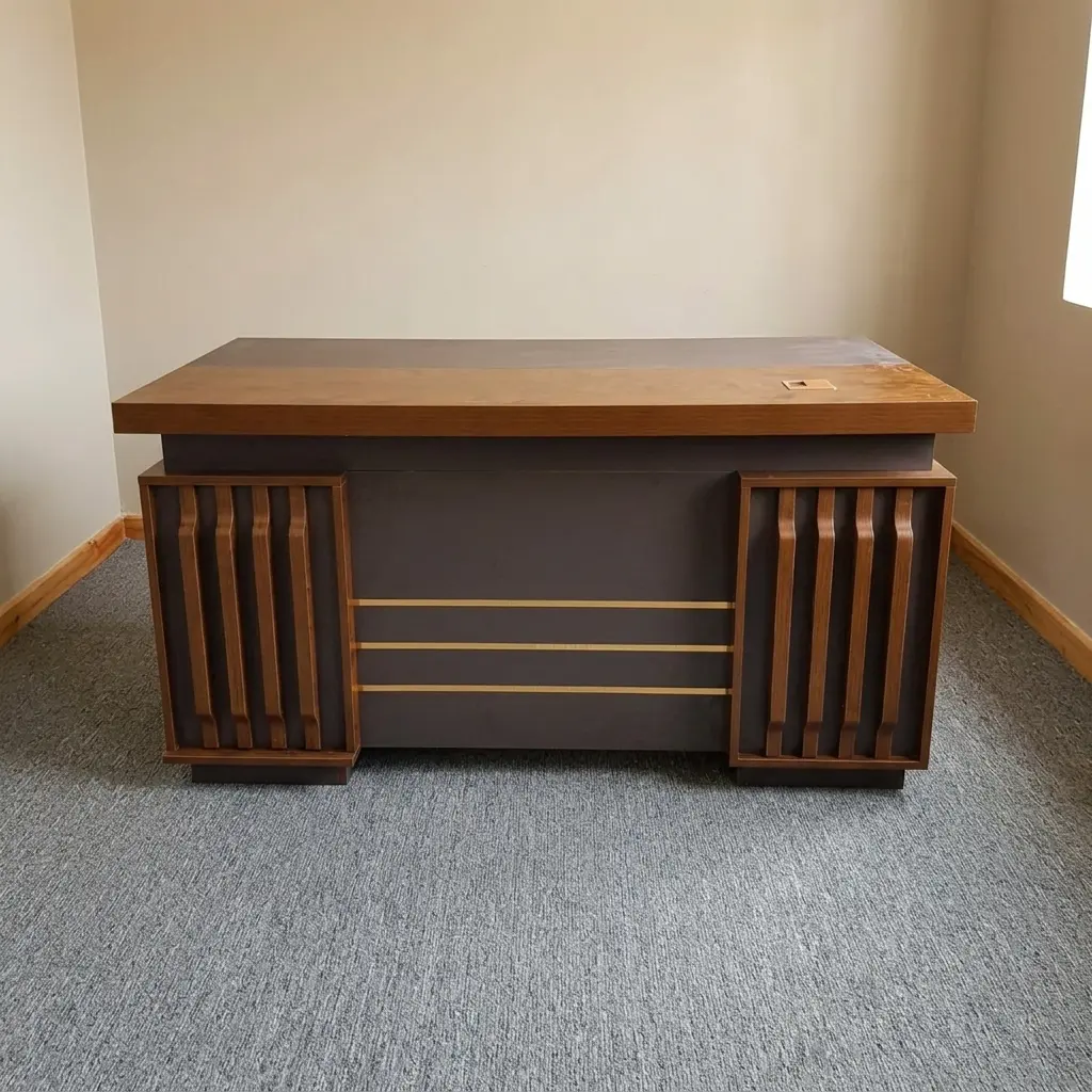 Modern 1400mm office table featuring a rich dark walnut wood-grain finish, built-in wire management grommets, an inlaid central writing surface, an integrated side cabinet, a three-drawer lockable pedestal with gold handles, and a decorative front modesty panel with vertical fluted wood accents and horizontal gold strip inlay.