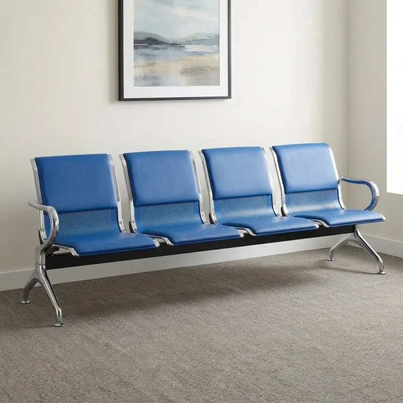Blue 4-link reception bench featuring blue leatherette padded seat and back cushions over perforated metal shells, chrome-plated side armrests and borders, a heavy-duty black crossbeam support, and angled chrome legs with adjustable leveling feet.