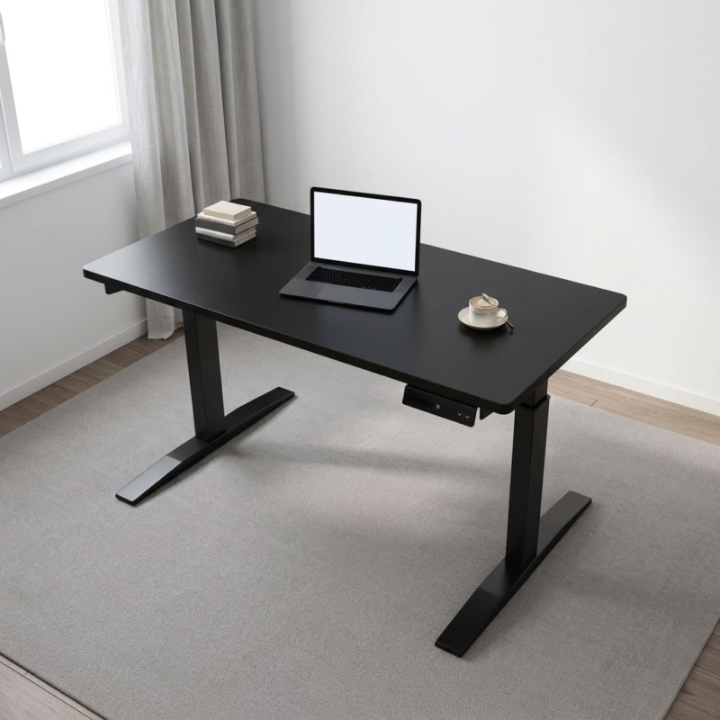 Black height-adjustable table featuring a smooth matte black laminate rectangular desktop with rounded corners, an under-desk digital keypad controller for electric elevation, and a heavy-duty black powder-coated steel motorized dual-stage T-frame leg structure with flat stabilizer feet.