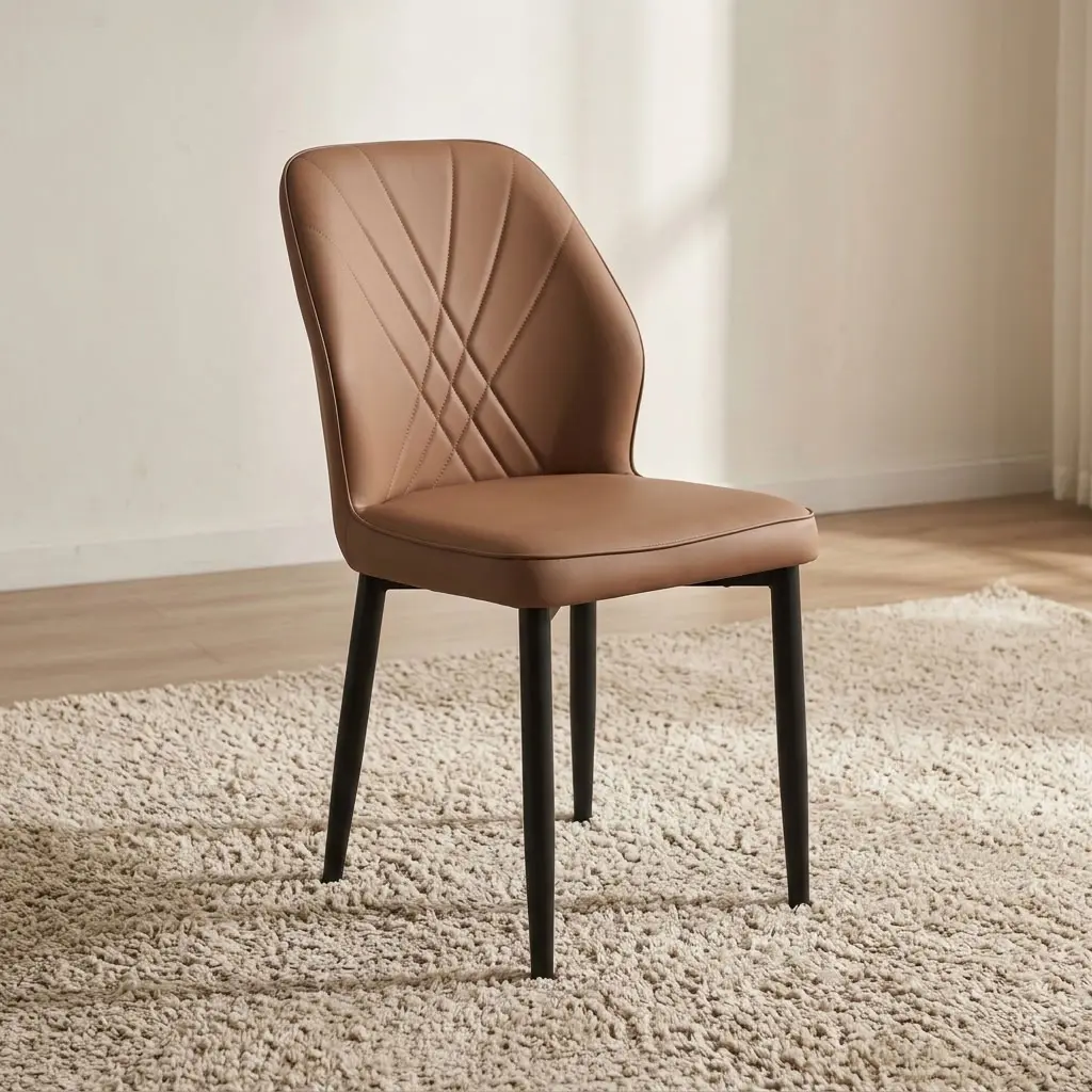 Brown leather dining chair featuring supple light tan-brown leatherette upholstery with cross-hatched accent stitching along the curved inner backrest, a cushioned contoured seat, an armless side chair profile, and matte black powder-coated steel tapered legs.