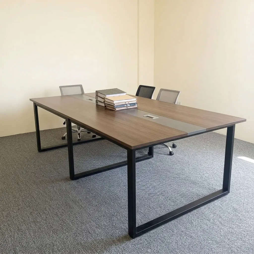 2.4metres boardroom table featuring a walnut wood-grain laminate desktop, a central grey cable management raceway inlay with integrated pop-up power/data access covers, and heavy-duty black powder-coated steel O-frame loop legs.