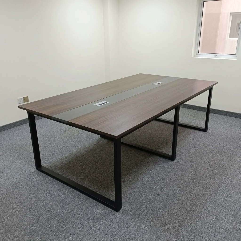 2.4metres boardroom table featuring a walnut wood-grain laminate desktop, a central grey cable management raceway inlay with integrated pop-up power/data access covers, and heavy-duty black powder-coated steel O-frame loop legs.