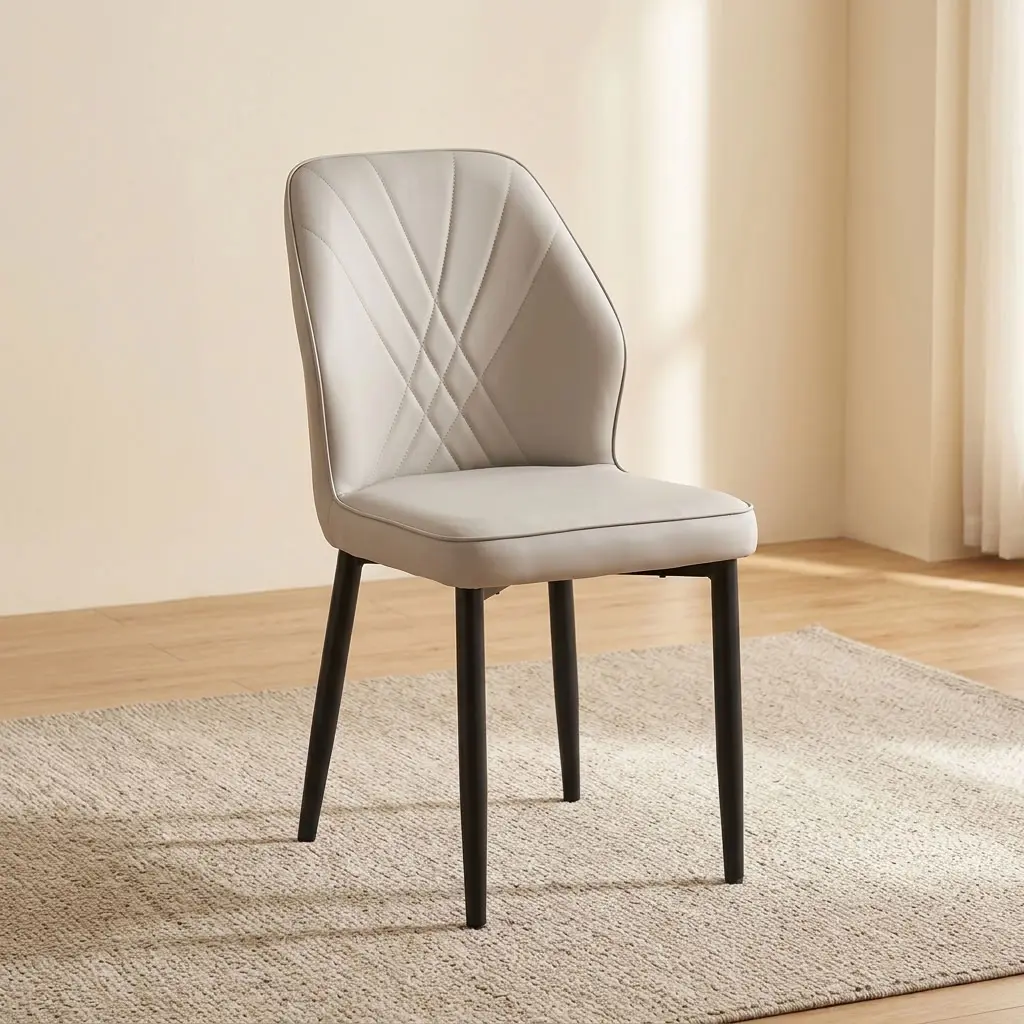 Modern leather dining chair featuring light gray faux leather upholstery with fan-style accent stitching on the inner backrest, a padded bucket-style seat with subtle side curves, an armless profile, and slim tapered black powder-coated metal legs.
