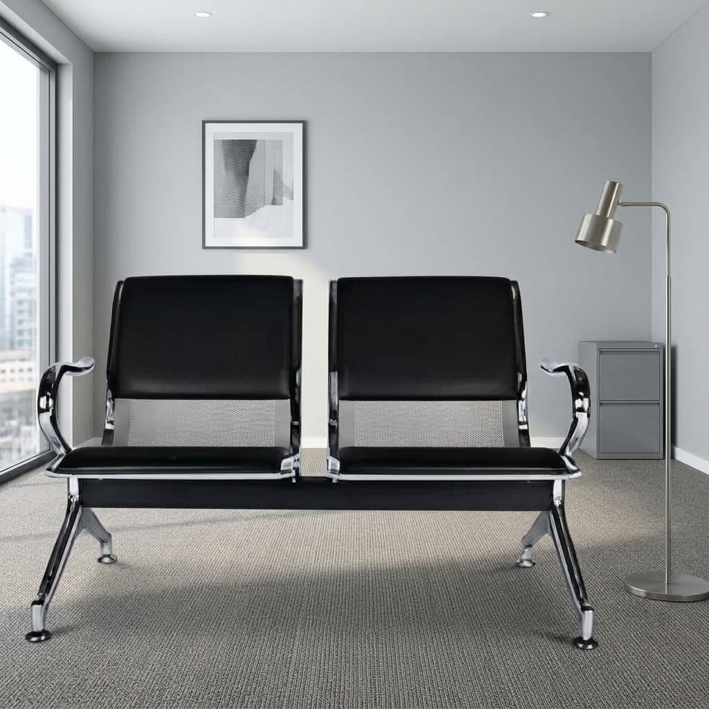 2-seater black padded bench featuring black faux leather padded backrests and seat cushions mounted on perforated steel frames, curved outer chrome armrests, a heavy-duty central beam support frame, and polished chrome angled legs with adjustable leveling feet.