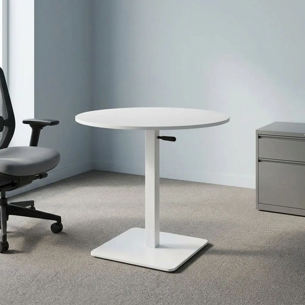Round height adjustable table featuring a smooth white laminate circular tabletop, a manual pneumatic adjustment lever located beneath the surface, a vertical white powder-coated steel center column, and a flat heavy-duty square steel pedestal base.